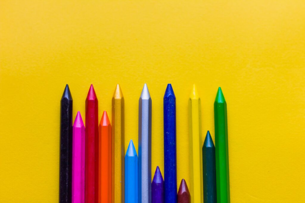 coloured pencils on a yellow background