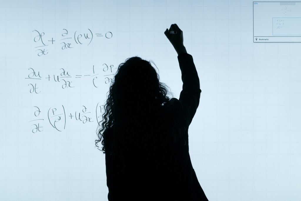 image of a figure in shadow writing on a whiteboard